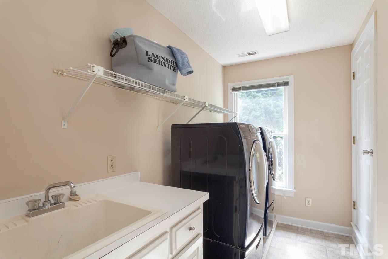 8016 Selfridge Court Raleigh, NC 27615 - Photo 19 of 25 a close view of a sink and a refrigerator in a kitchen