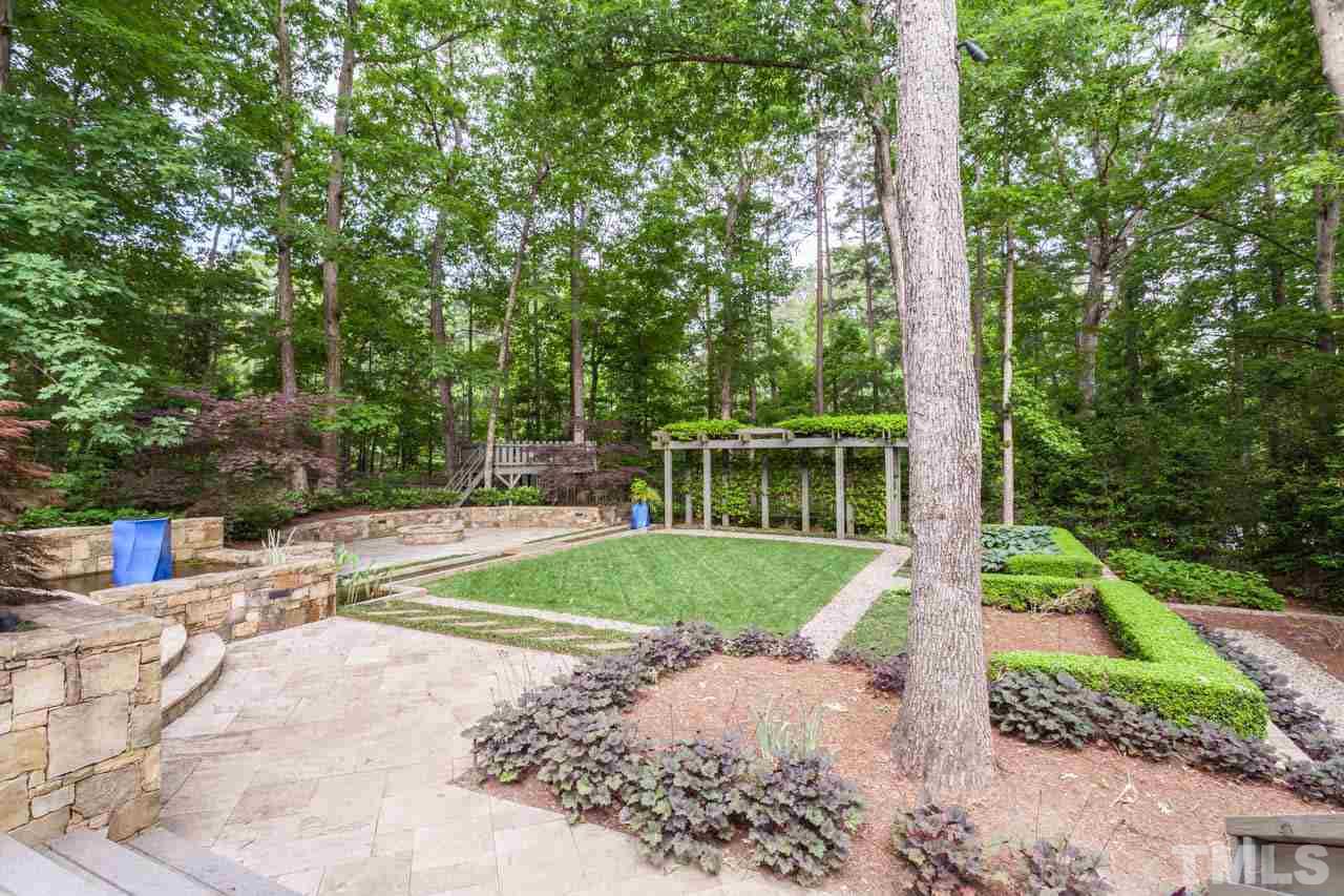 8016 Selfridge Court Raleigh, NC 27615 - Photo 25 of 25 a view of a house with a yard and sitting area