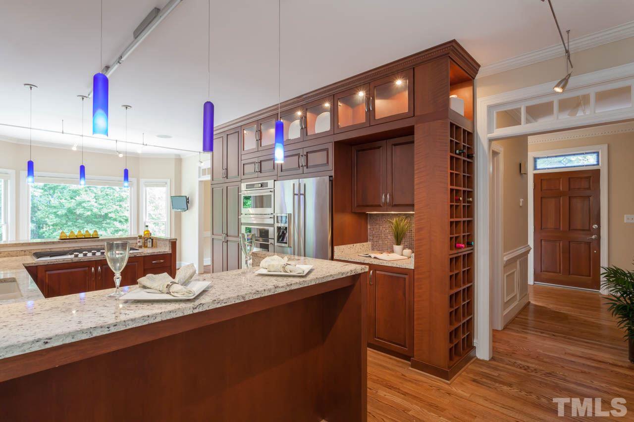 8016 Selfridge Court Raleigh, NC 27615 - Photo 5 of 25 a kitchen with granite countertop a sink cabinets and wooden floor