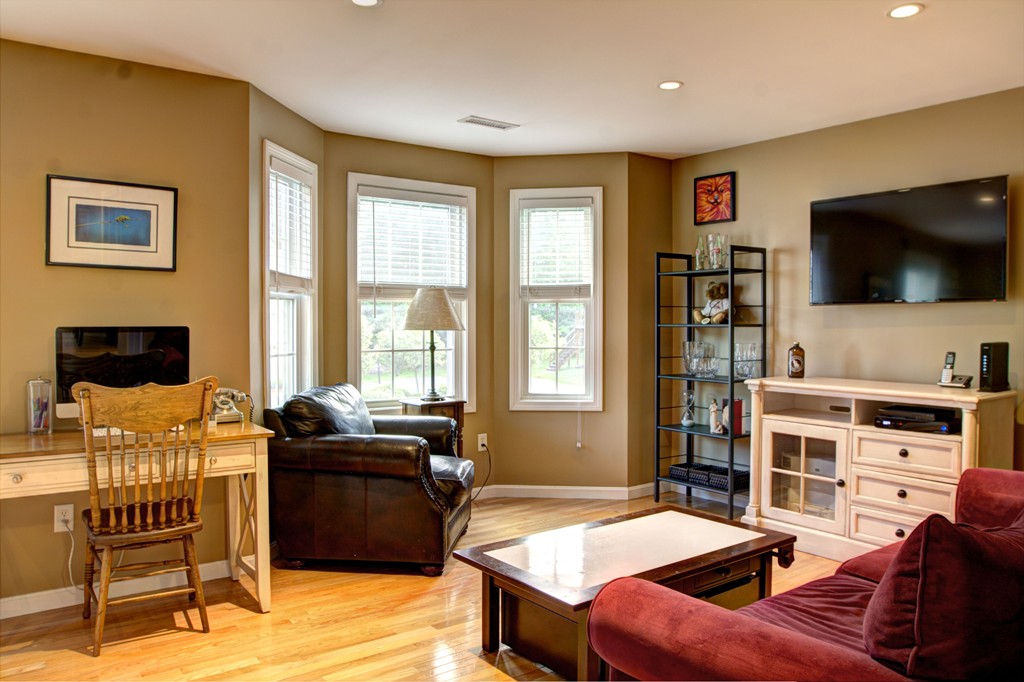262 Littleton Road, Unit 22 Chelmsford, MA 01824 - Photo 13 of 30 a bedroom with furniture and a flat screen tv