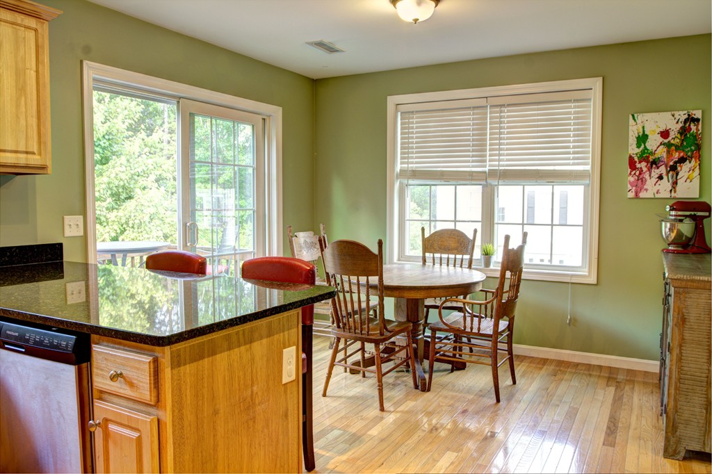 262 Littleton Road, Unit 22 Chelmsford, MA 01824 - Photo 2 of 30 a table and chairs in a room next to a window