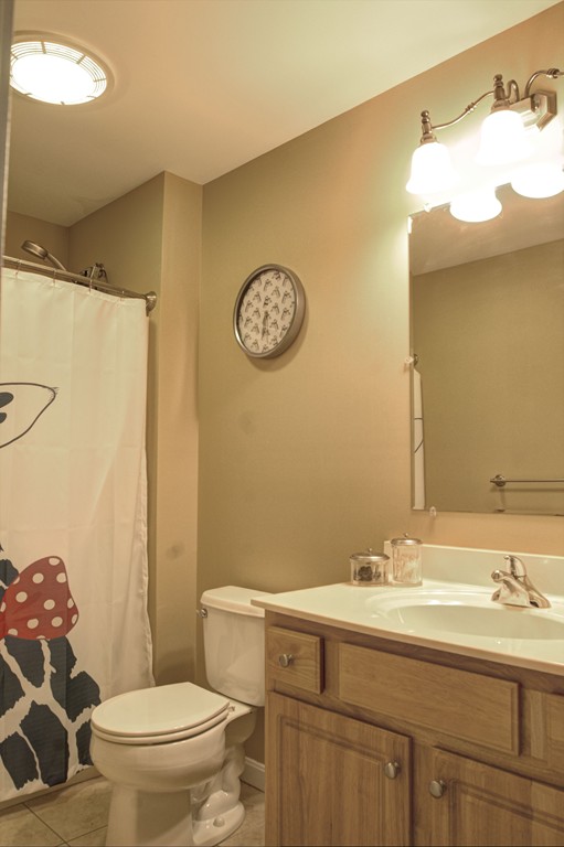 262 Littleton Road, Unit 22 Chelmsford, MA 01824 - Photo 22 of 30 a bathroom with a sink mirror vanity and toilet