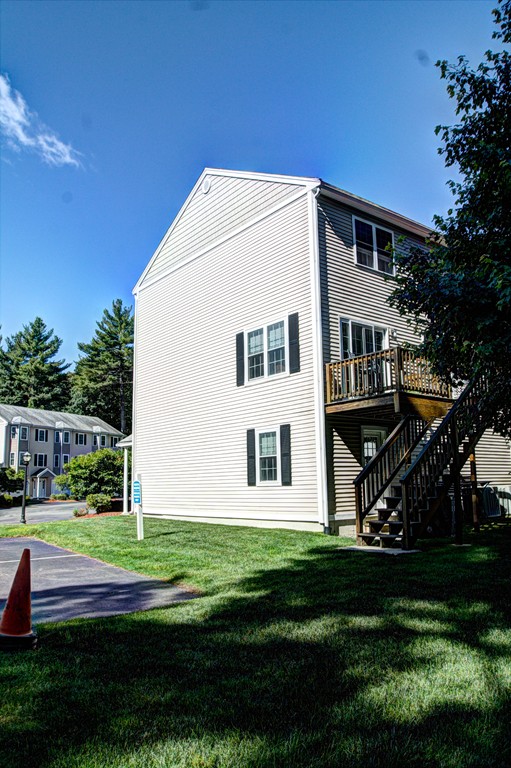 262 Littleton Road, Unit 22 Chelmsford, MA 01824 - Photo 29 of 30 a front view of a house with a yard