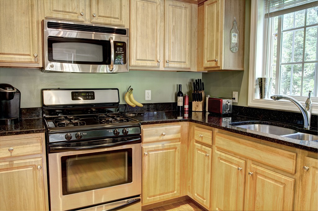 262 Littleton Road, Unit 22 Chelmsford, MA 01824 - Photo 5 of 30 a kitchen with granite countertop cabinets stainless steel appliances and a window