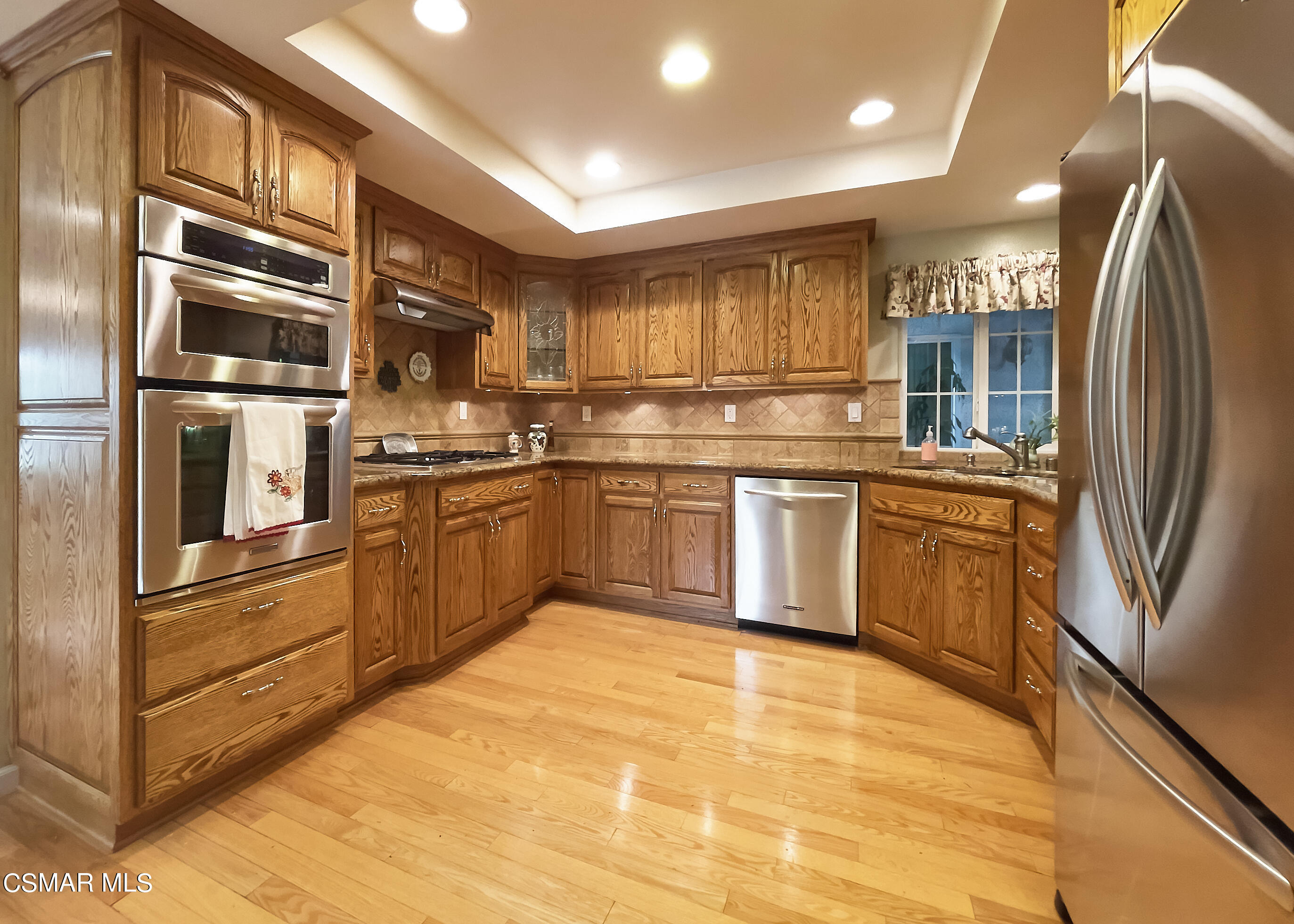 4110 Oakcliff Drive Moorpark, CA 93021 - Photo 36 of 67 a kitchen with stainless steel appliances granite countertop a refrigerator and a stove top oven