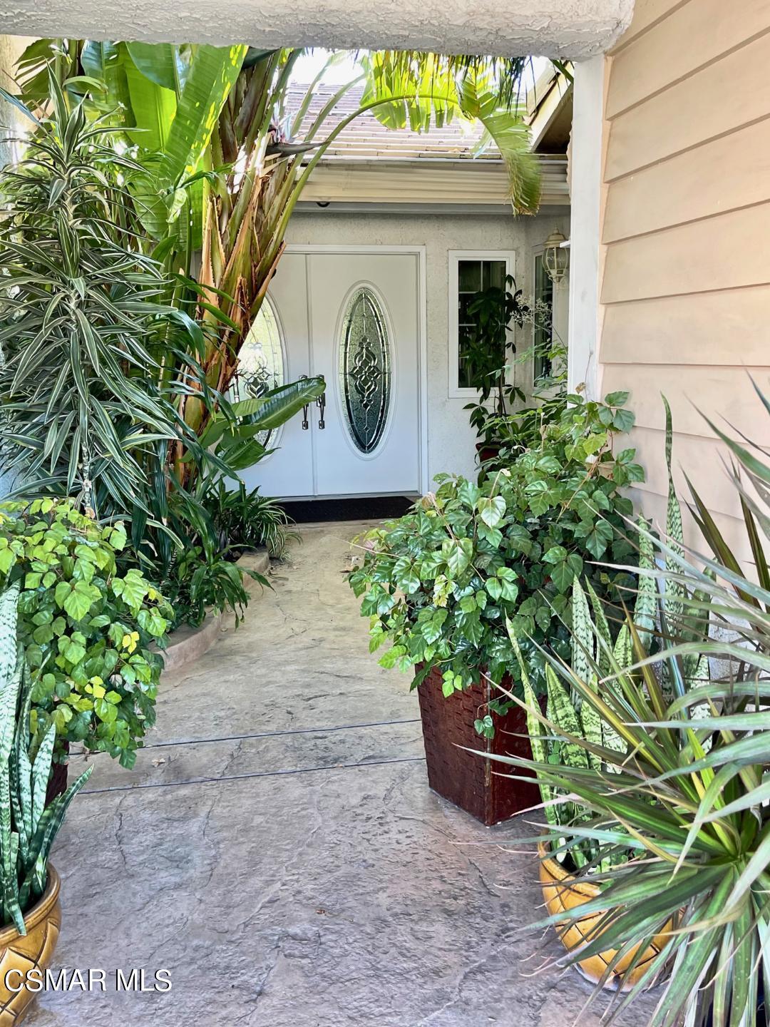 4110 Oakcliff Drive Moorpark, CA 93021 - Photo 4 of 67 a potted plant is sitting in front of a door