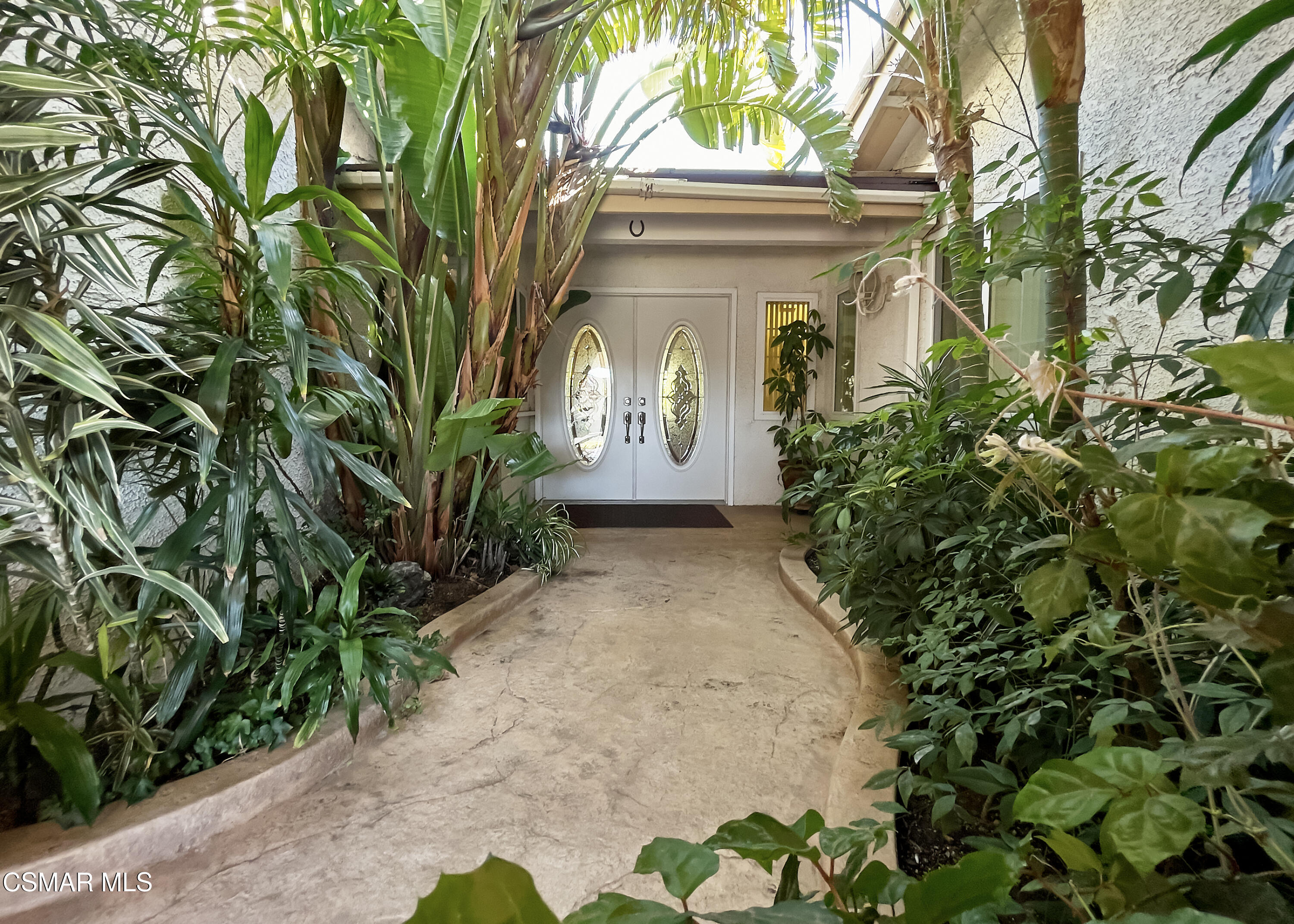 4110 Oakcliff Drive Moorpark, CA 93021 - Photo 5 of 67 a front view of a house with a yard and a tree