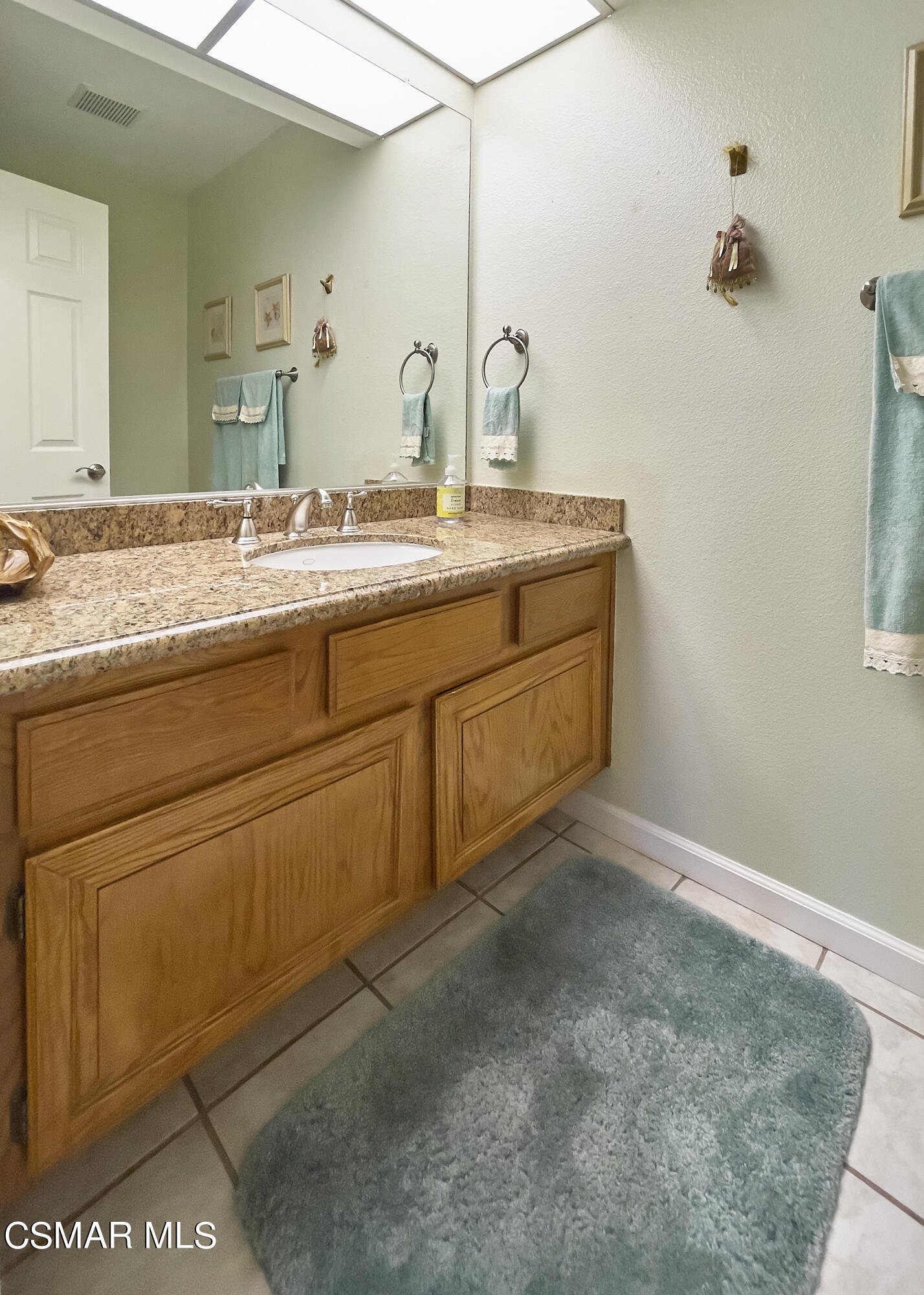 4110 Oakcliff Drive Moorpark, CA 93021 - Photo 51 of 67 a bathroom with a sink and a mirror