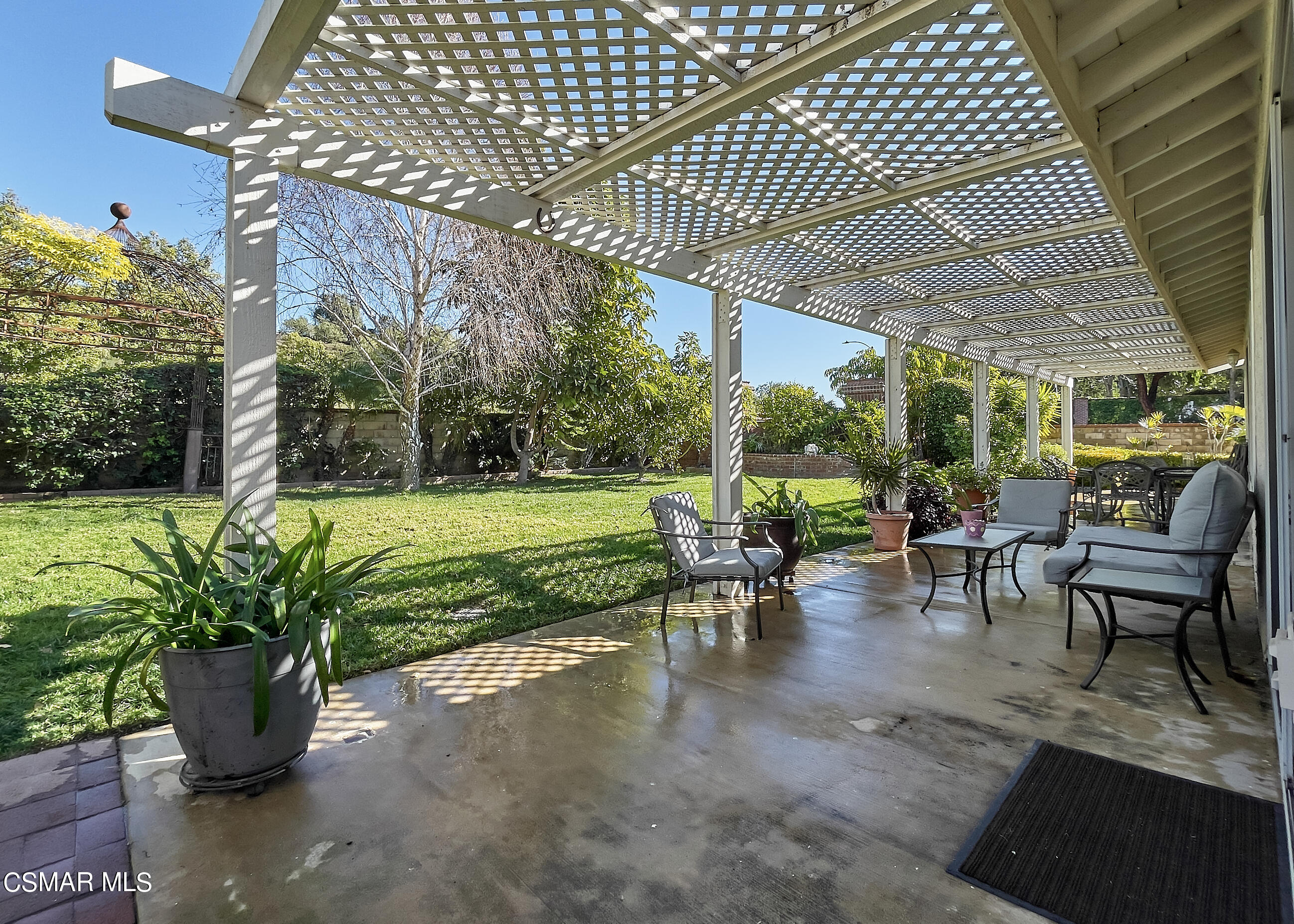 4110 Oakcliff Drive Moorpark, CA 93021 - Photo 57 of 67 a view of a patio with table and chairs potted plants and large tree
