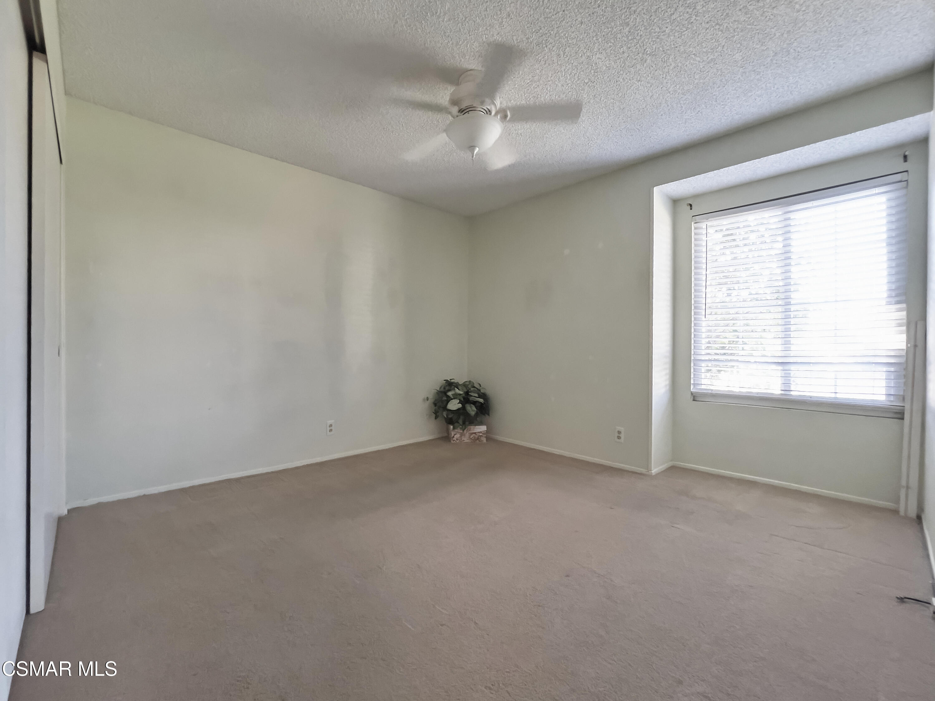 4110 Oakcliff Drive Moorpark, CA 93021 - Photo 65 of 67 an empty room with a ceiling fan and window