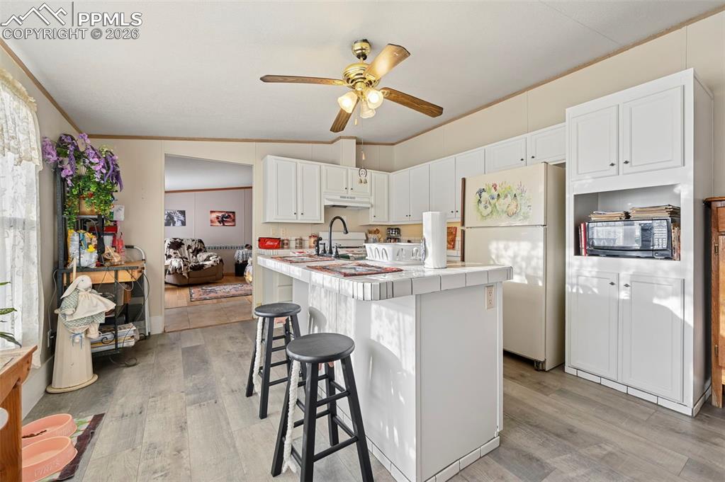 35875 Shear Road Yoder, CO 80864 - Photo 18 of 45 a kitchen view with stainless steel appliances kitchen island granite countertop furniture and a refrigerator