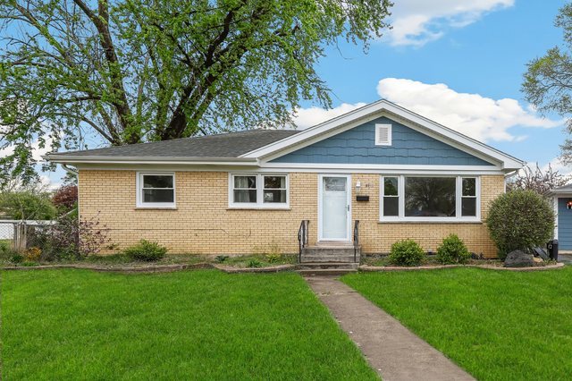 5932 107th Place Chicago Ridge, IL 60415 - Photo 1 of 22 a front view of a house with a yard and garden