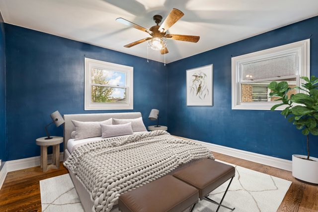 5932 107th Place Chicago Ridge, IL 60415 - Photo 11 of 22 a bedroom with a large bed and a chandelier