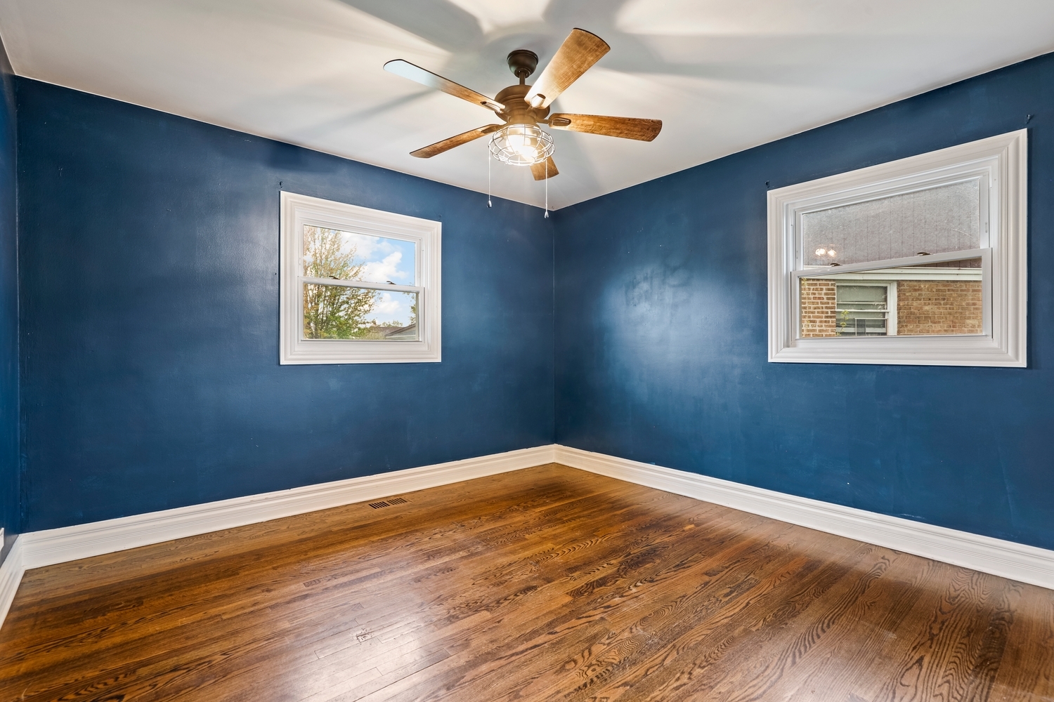 5932 107th Place Chicago Ridge, IL 60415 - Photo 12 of 22 a view of an empty room with window and wooden floor