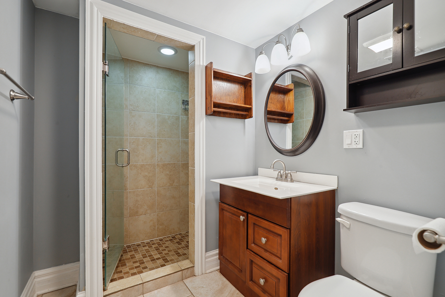 5932 107th Place Chicago Ridge, IL 60415 - Photo 18 of 22 a bathroom with a toilet a sink and a mirror