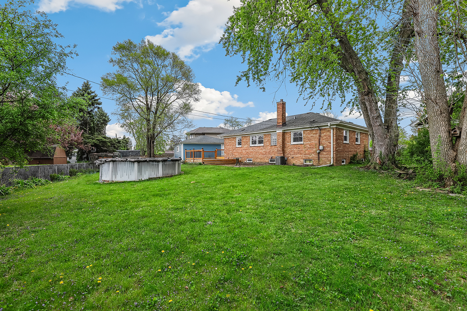 5932 107th Place Chicago Ridge, IL 60415 - Photo 20 of 22 a view of a house with a big yard and large trees