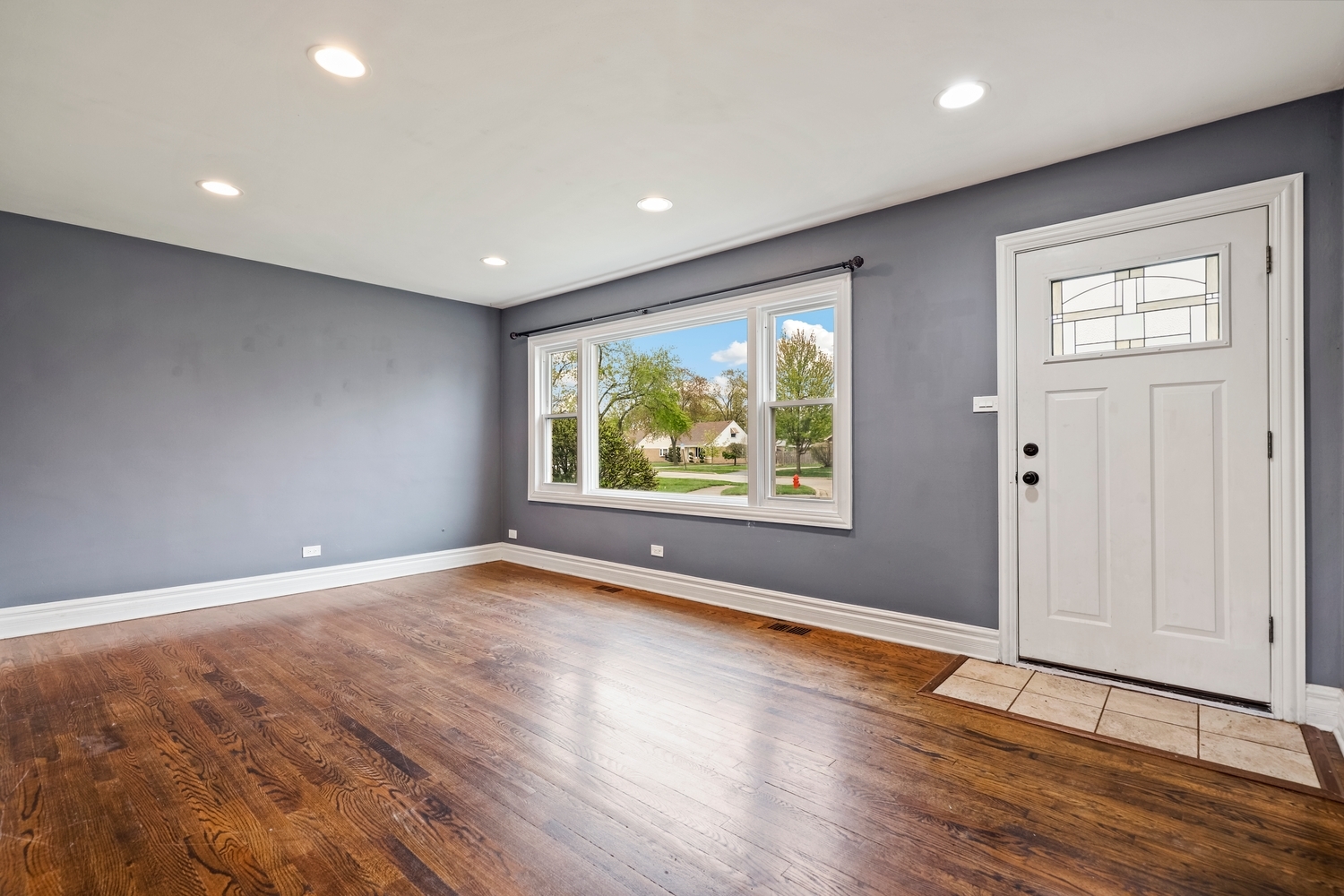 5932 107th Place Chicago Ridge, IL 60415 - Photo 3 of 22 a view of an empty room with wooden floor and window