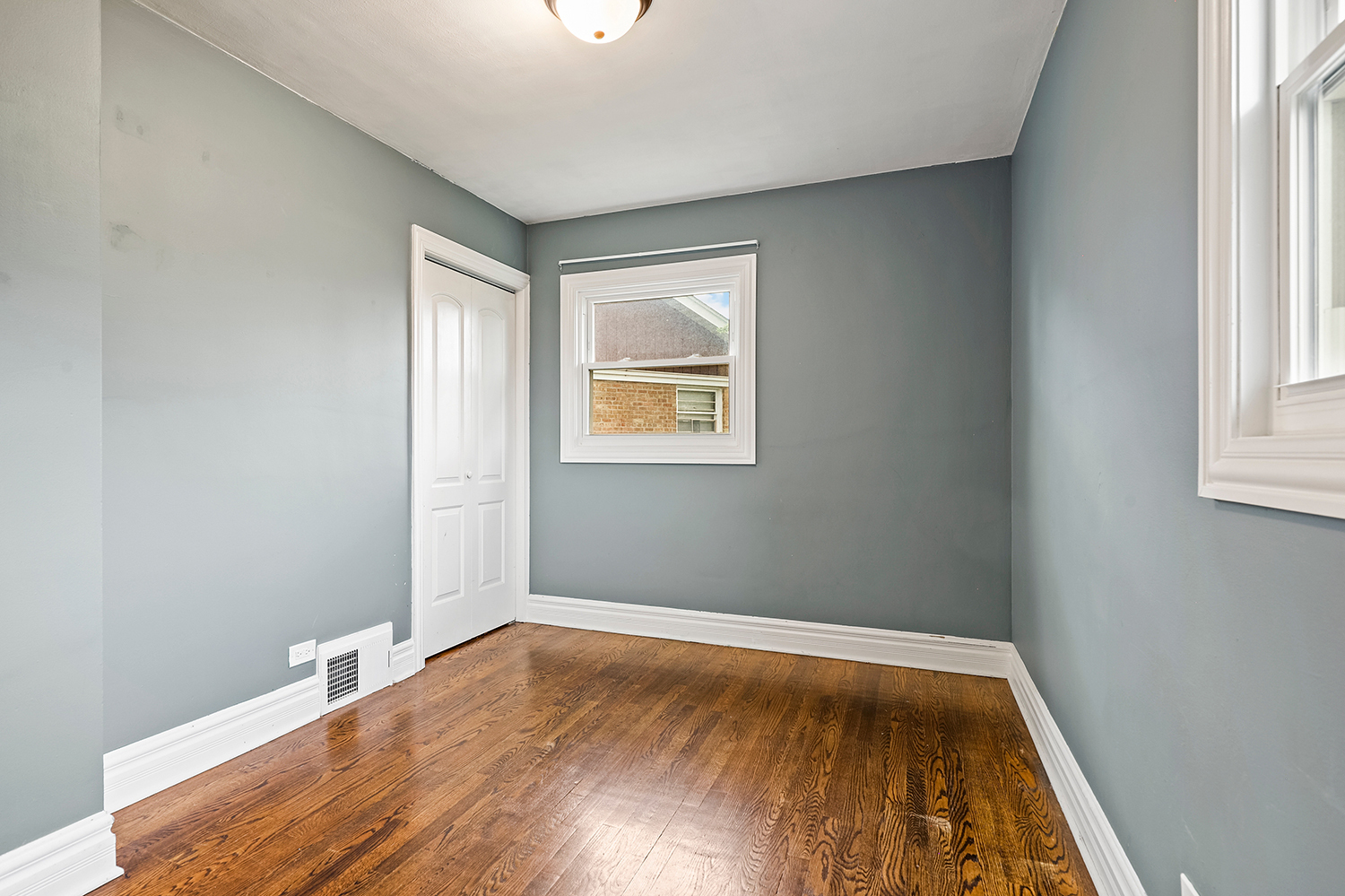 5932 107th Place Chicago Ridge, IL 60415 - Photo 10 of 22 an empty room with wooden floor and windows