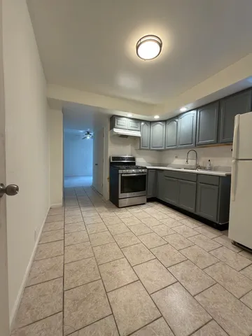 a large kitchen with cabinets and stainless steel appliances