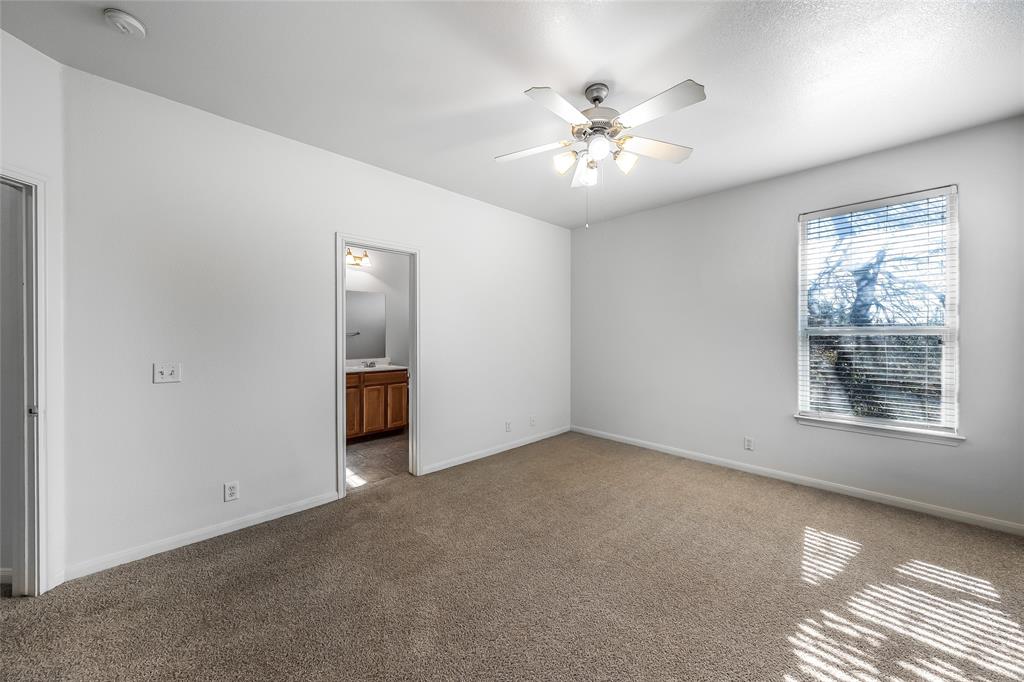 2518 Allred Drive, Unit A Austin, TX 78748 - Photo 7 of 16 Unfurnished bedroom featuring carpet flooring, ceiling fan, and connected bathroom
