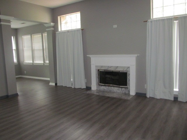 4740 Billingsgate Road Antioch, TN 37013 - Photo 2 of 5 an empty room with wooden floor fireplace and windows