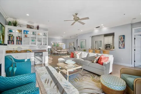 a living room with furniture a large window and a flat screen tv