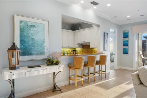 a living room with furniture a large window and a flat screen tv