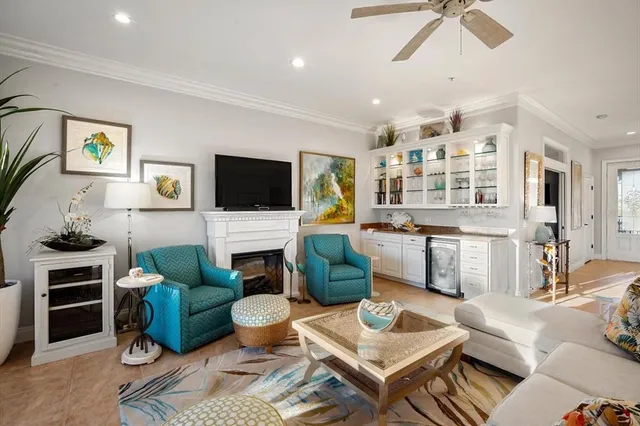 a living room with furniture a fireplace and a flat screen tv