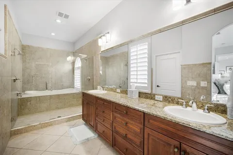 a bedroom with two beds and a chandelier