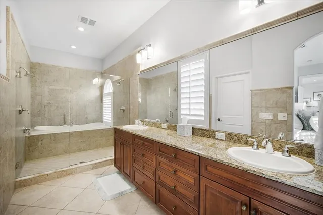 a bedroom with two beds and a chandelier