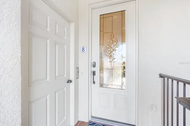a view of a sign board with a small yard and wooden fence