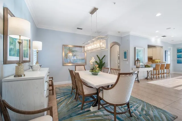 a kitchen with stainless steel appliances kitchen island granite countertop a table and chairs in it