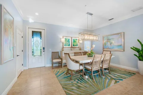 a dining room with furniture and a window