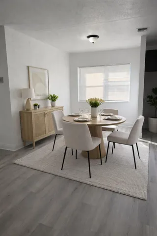 a dining room with furniture and window