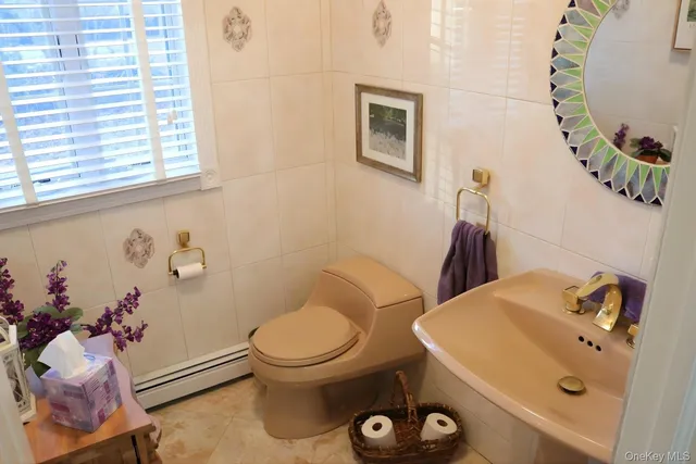 a bathroom with a sink mirror and toilet