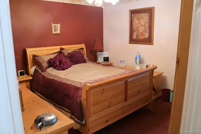 a bed sitting in a bedroom next to a small yard