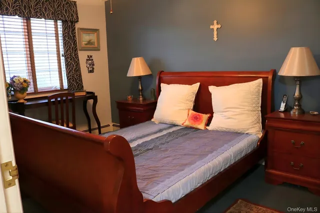 a bed sitting in a bedroom next to a window