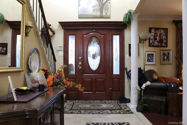 a living room with furniture a mirror and a wooden floor