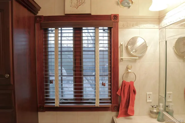 a view of a bathroom with a shower and a window