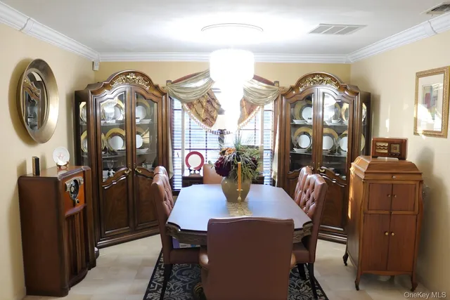 a view of a dining room with furniture and chandelier