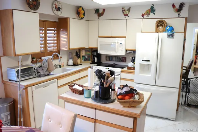 a kitchen with a refrigerator and a sink