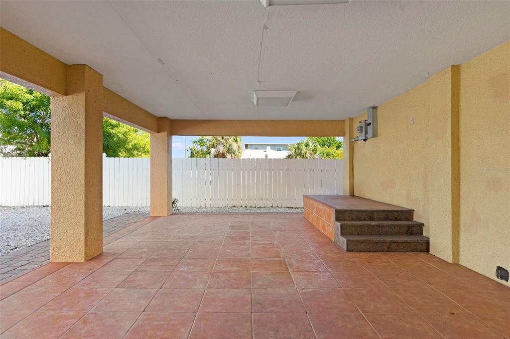 114 143rd Avenue, Unit B Madeira Beach, FL 33708 - Photo 12 of 14 a view of an empty room with wooden floor and a window
