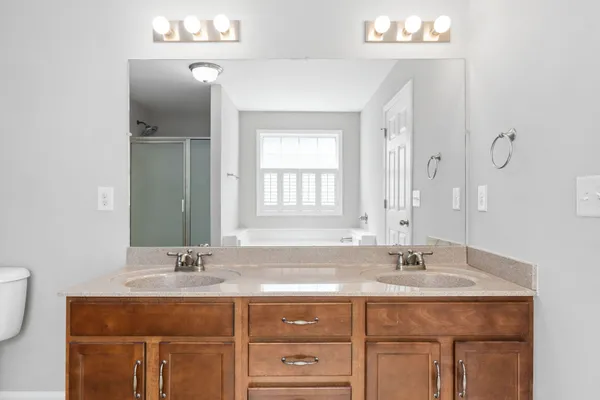 a bathroom with a sink vanity and mirror