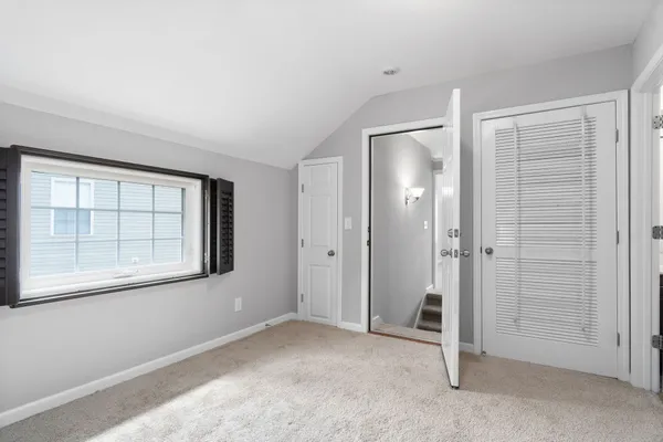 an empty room with windows and closet