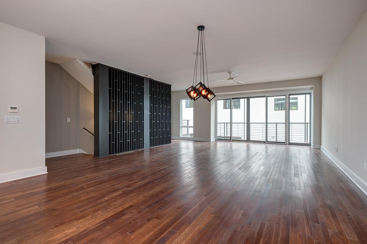 2106 9th Avenue North, Unit 3 Nashville, TN 37228 - Photo 14 of 30 a view of an empty room with wooden floor and a window