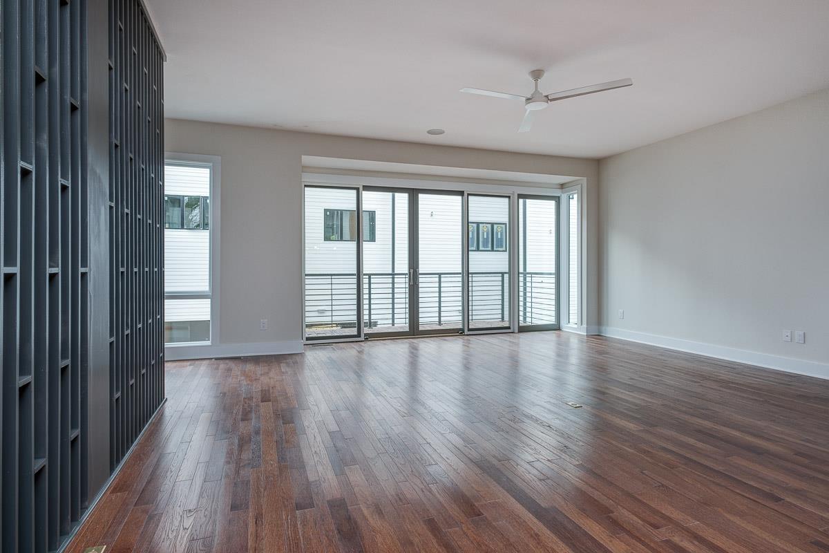2106 9th Avenue North, Unit 3 Nashville, TN 37228 - Photo 16 of 30 a view of an empty room with wooden floor and a window