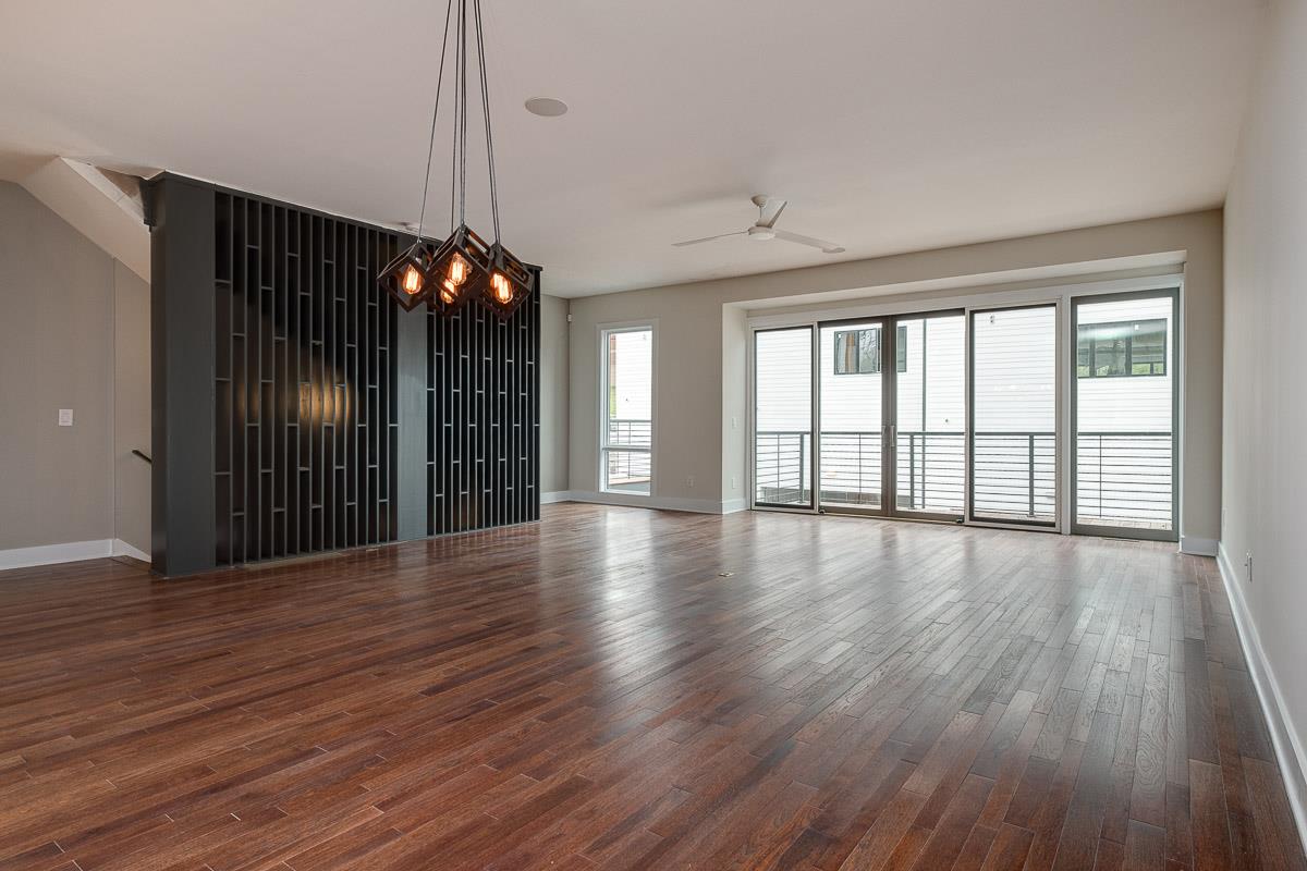 2106 9th Avenue North, Unit 3 Nashville, TN 37228 - Photo 17 of 30 a view of an empty room with wooden floor and a window