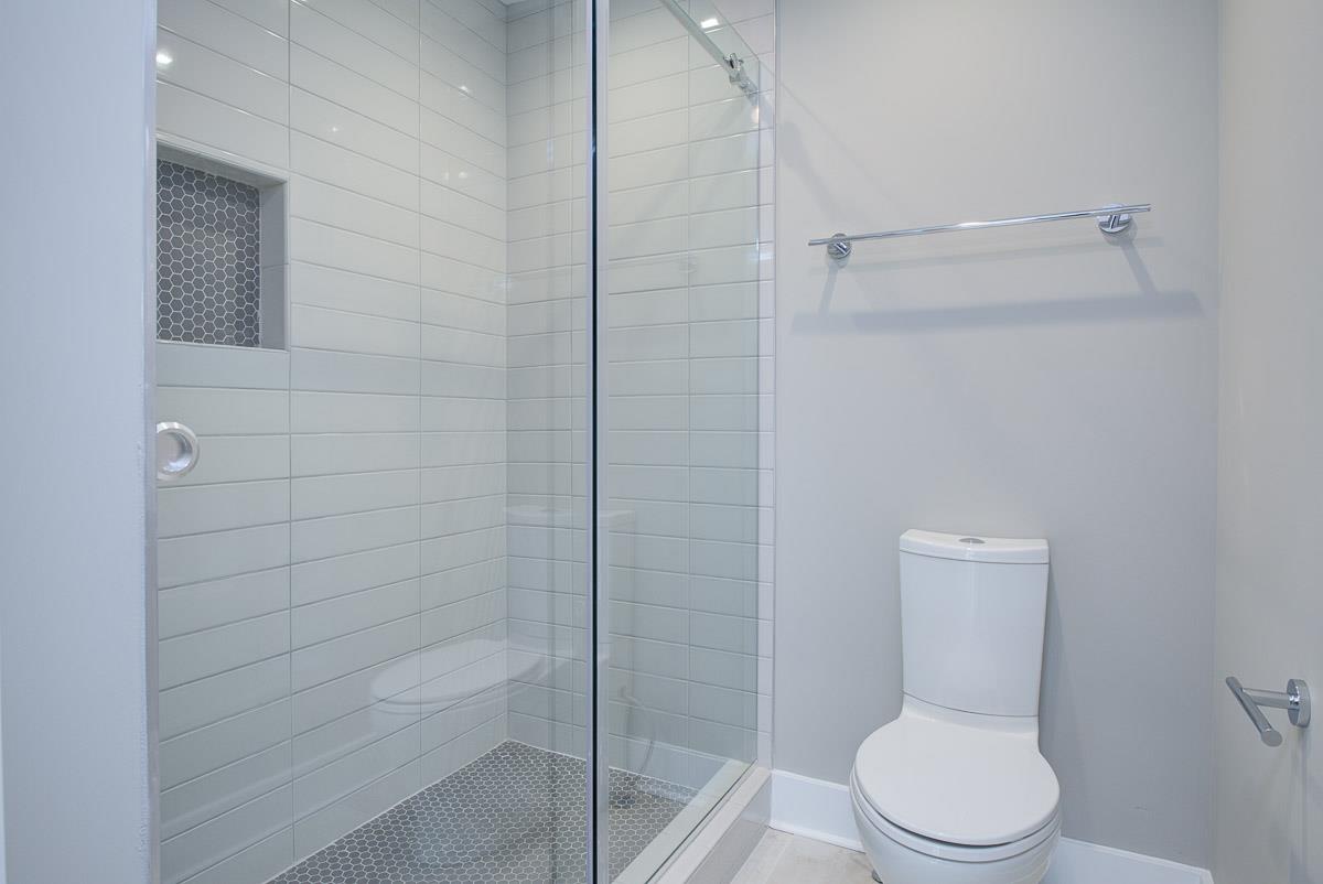 2106 9th Avenue North, Unit 3 Nashville, TN 37228 - Photo 21 of 30 a white toilet and tub next to a shower