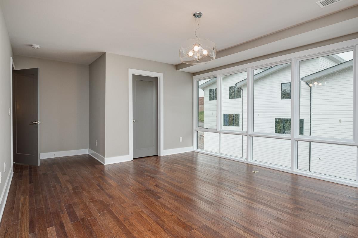 2106 9th Avenue North, Unit 3 Nashville, TN 37228 - Photo 23 of 30 a view of an empty room with wooden floor and a window