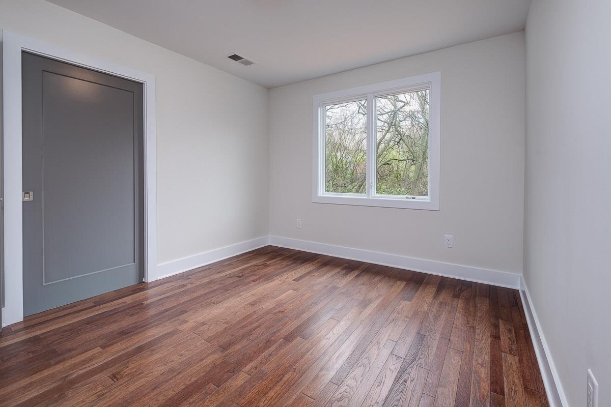 2106 9th Avenue North, Unit 3 Nashville, TN 37228 - Photo 25 of 30 a view of an empty room with wooden floor and a window